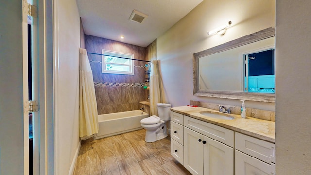 full bathroom with hardwood / wood-style flooring, vanity, shower / tub combo with curtain, and toilet