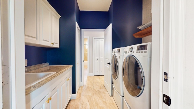 washroom featuring cabinets and separate washer and dryer