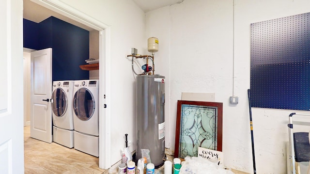 laundry area with water heater and washing machine and dryer