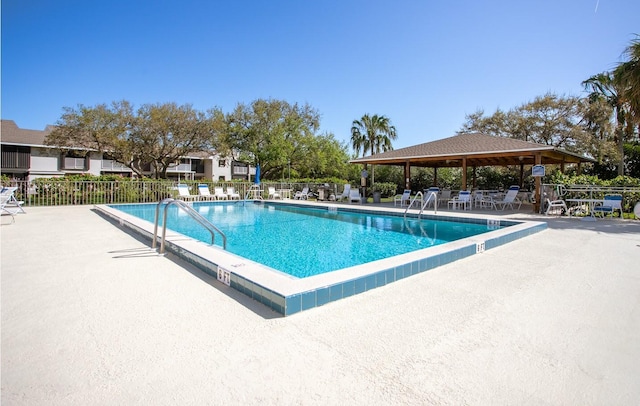 view of swimming pool featuring a patio area and a gazebo