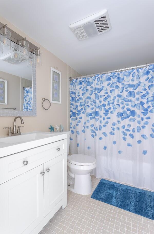 bathroom with tile patterned floors, vanity, and toilet