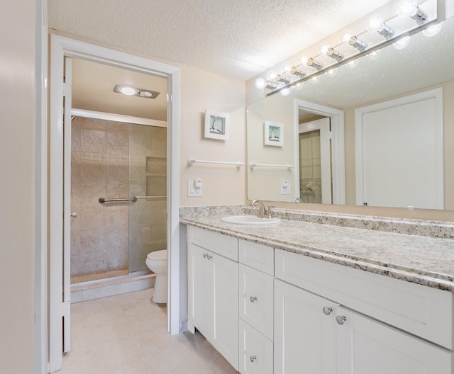 bathroom with toilet, a shower with shower door, a textured ceiling, tile patterned floors, and vanity