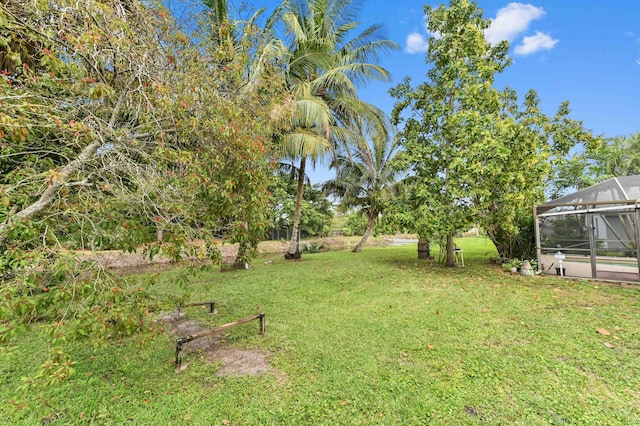 view of yard featuring glass enclosure