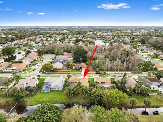 drone / aerial view with a water view and a residential view