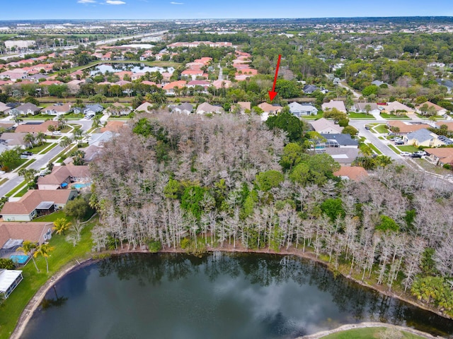 birds eye view of property featuring a water view and a residential view