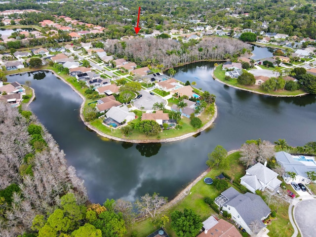 drone / aerial view with a water view and a residential view