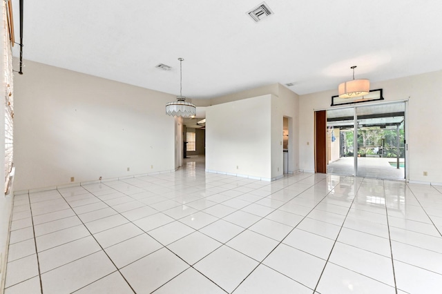 unfurnished room featuring light tile patterned flooring, visible vents, and baseboards