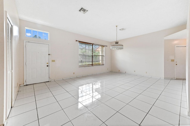 entrance foyer featuring light tile patterned floors and visible vents