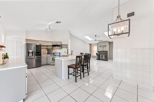 kitchen featuring light tile patterned floors, visible vents, stainless steel appliances, and a sink