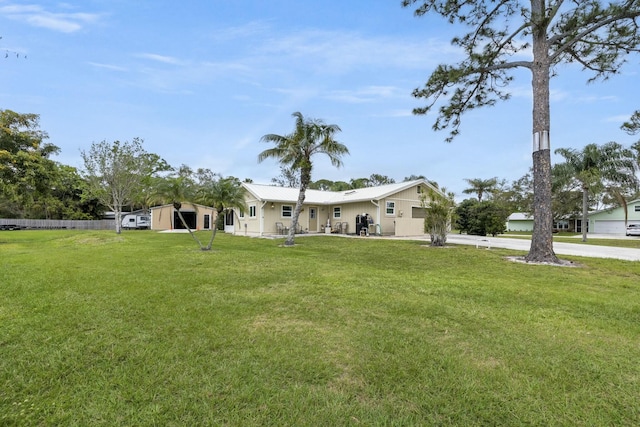 2103 SE Meadowbrook Rd, Stuart, FL 34997 - view of yard featuring driveway, an attached garage, and fence