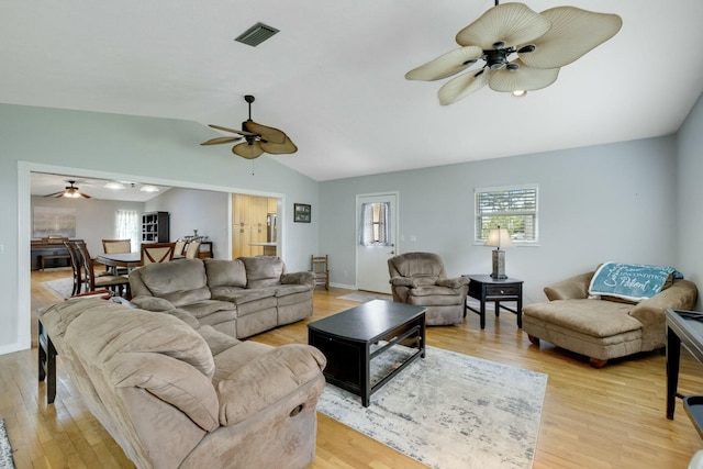 2103 SE Meadowbrook Rd, Stuart, FL 34997 - living area featuring lofted ceiling, light wood finished floors, visible vents, and a ceiling fan