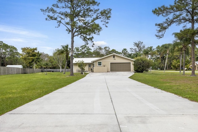 ranch-style home with a garage, driveway, a front yard, and fence