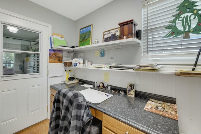 2103 SE Meadowbrook Rd, Stuart, FL 34997 - office area featuring built in desk, a healthy amount of sunlight, and light wood-style flooring