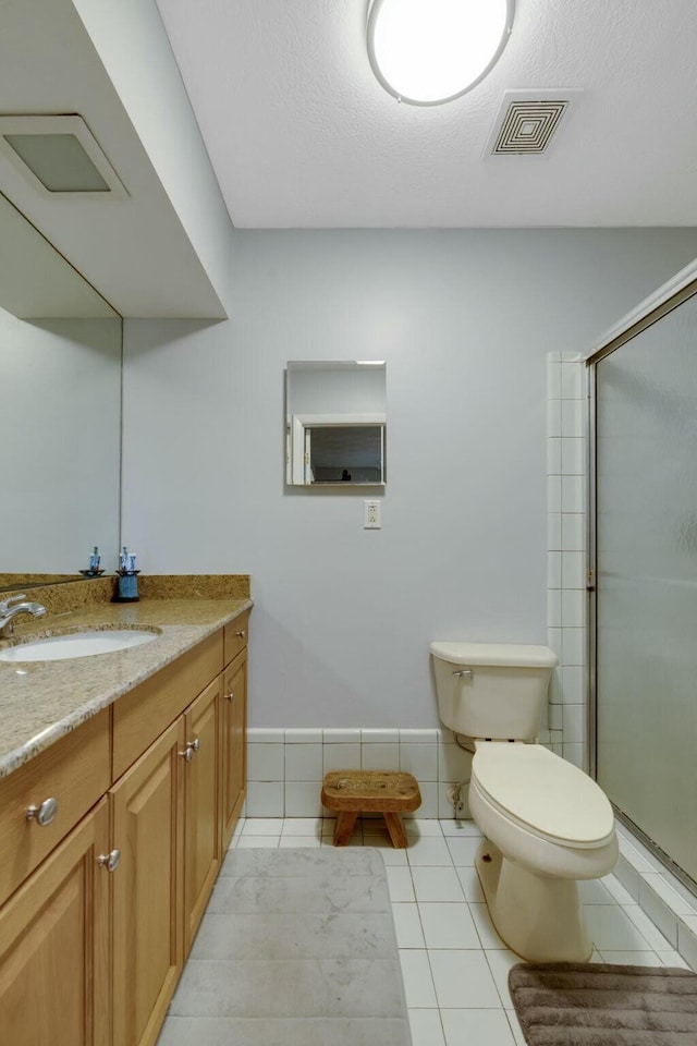 2103 SE Meadowbrook Rd, Stuart, FL 34997 - bathroom featuring tile patterned flooring, toilet, vanity, visible vents, and a shower with door