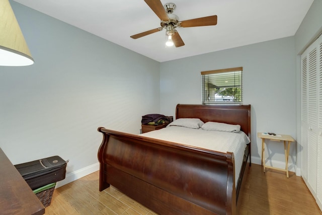 2103 SE Meadowbrook Rd, Stuart, FL 34997 - bedroom featuring light wood-style floors, a closet, baseboards, and a ceiling fan