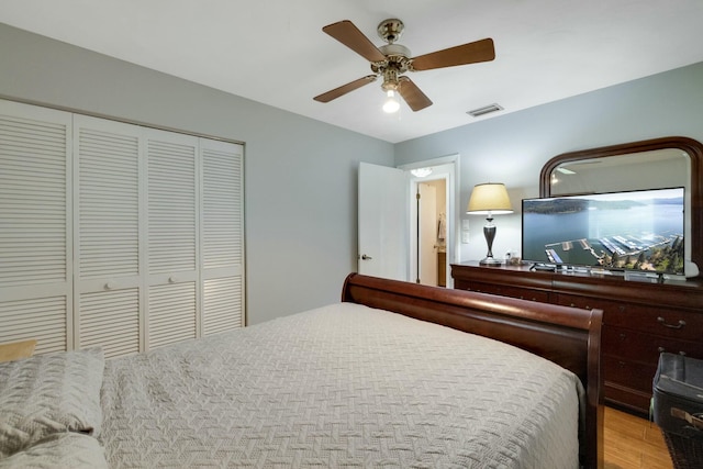 2103 SE Meadowbrook Rd, Stuart, FL 34997 - bedroom with a closet, light wood-type flooring, visible vents, and a ceiling fan