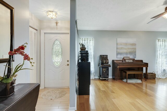 2103 SE Meadowbrook Rd, Stuart, FL 34997 - entryway featuring light wood-style floors, ceiling fan, and a textured ceiling