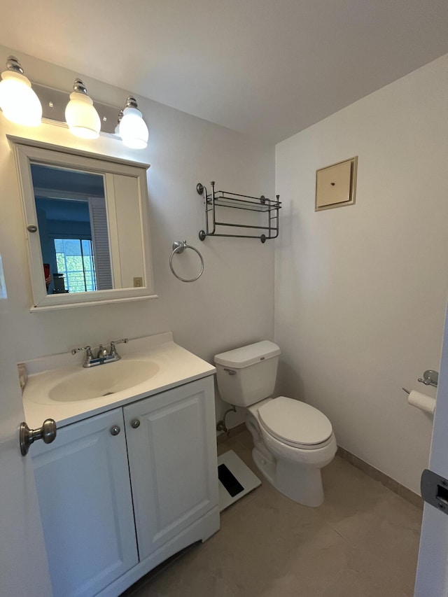 bathroom with toilet and vanity