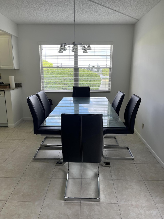 dining space with a textured ceiling, a notable chandelier, a wealth of natural light, and light tile patterned floors