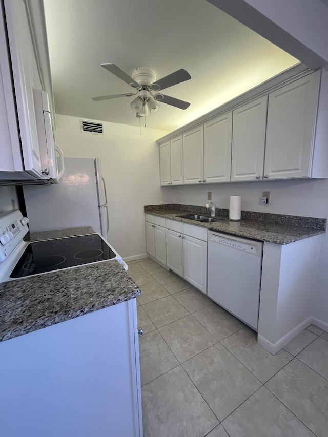 kitchen featuring white appliances, white cabinetry, sink, and light tile patterned flooring