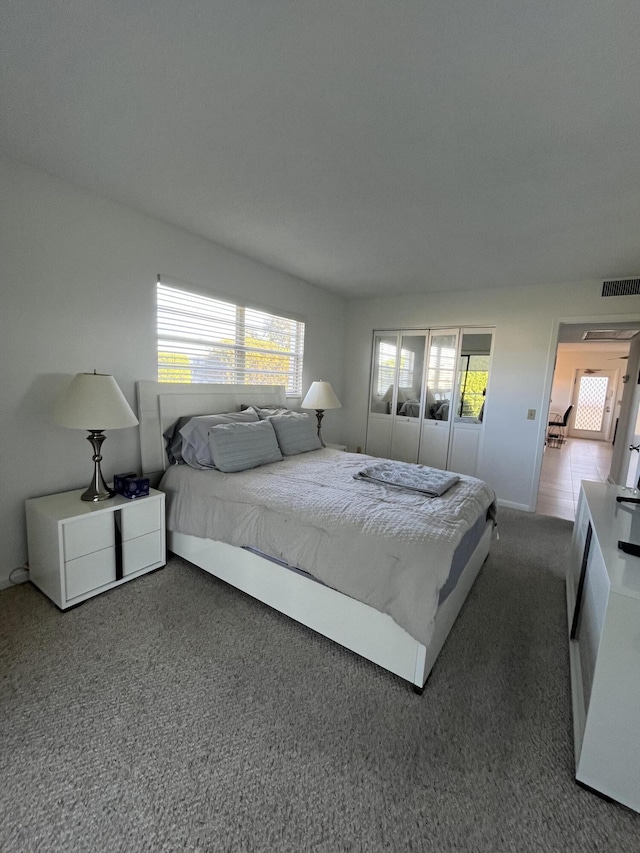 bedroom featuring dark carpet