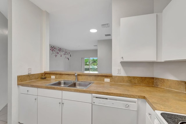 kitchen with white cabinets, a sink, and white appliances