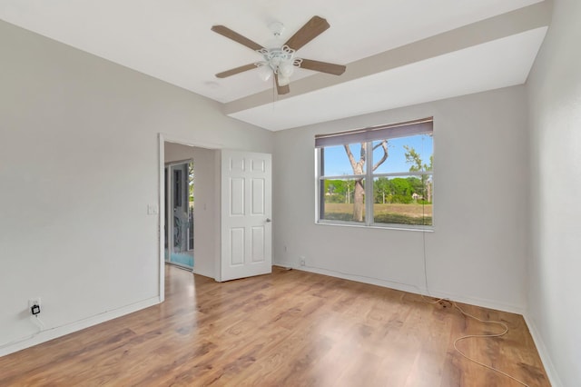 spare room with light wood-style flooring, baseboards, and ceiling fan