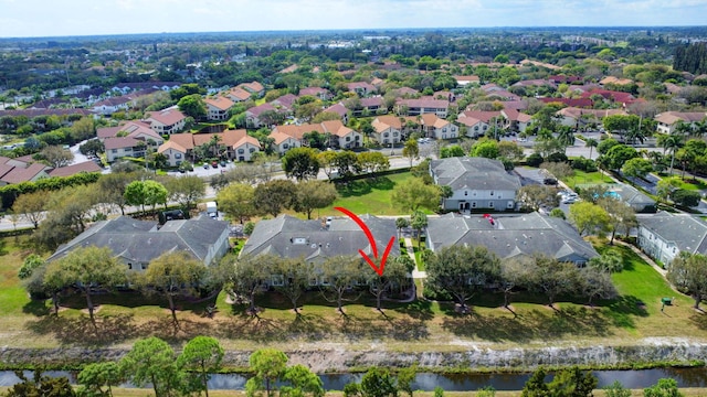 drone / aerial view with a residential view and a water view