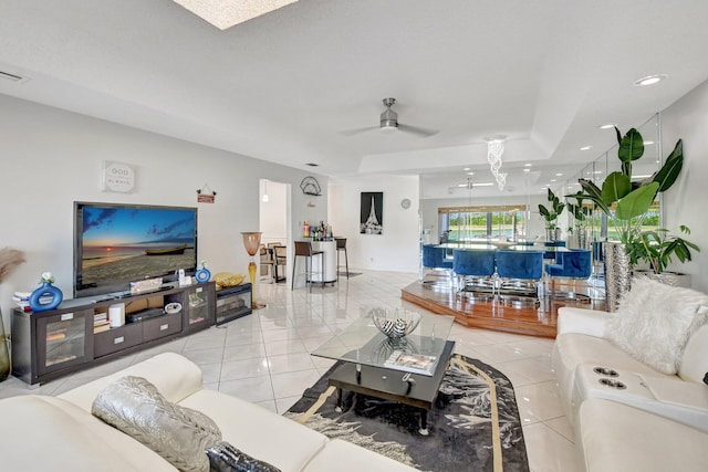 living area featuring ceiling fan and light tile patterned flooring