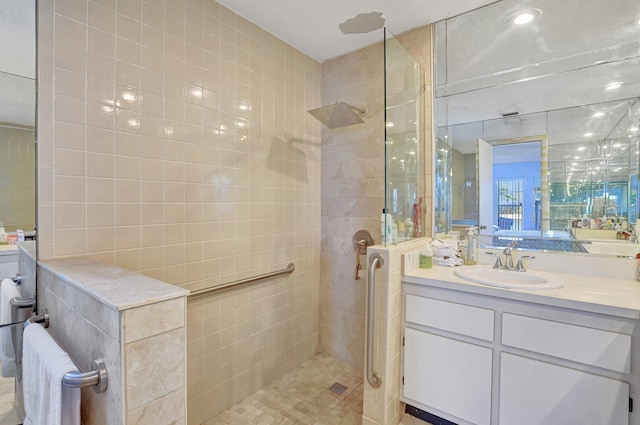 full bathroom featuring vanity and a walk in shower