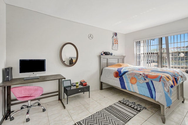 bedroom featuring light tile patterned floors and baseboards