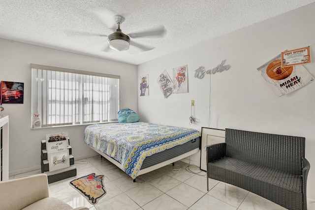 bedroom with light tile patterned flooring, ceiling fan, and a textured ceiling