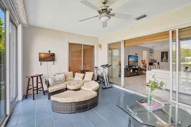 sunroom featuring ceiling fan and visible vents