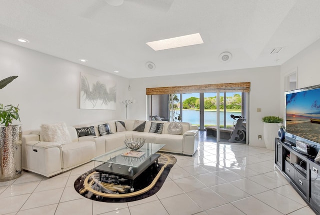 living room with light tile patterned floors, a skylight, visible vents, and recessed lighting