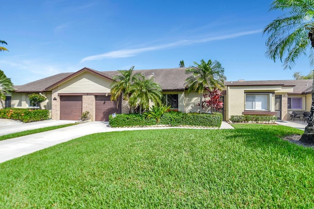 ranch-style home with a garage, brick siding, driveway, and a front yard