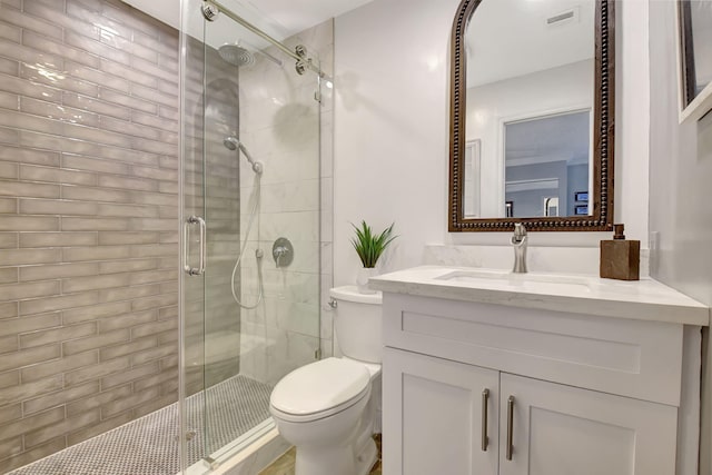 full bath with toilet, a shower stall, visible vents, and vanity