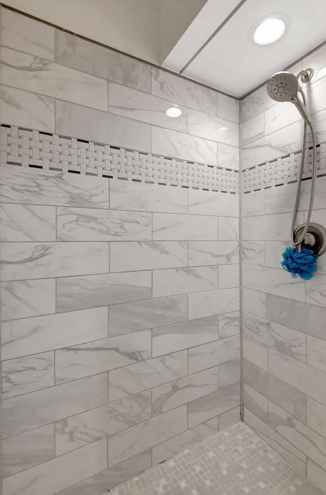 bathroom with tiled shower