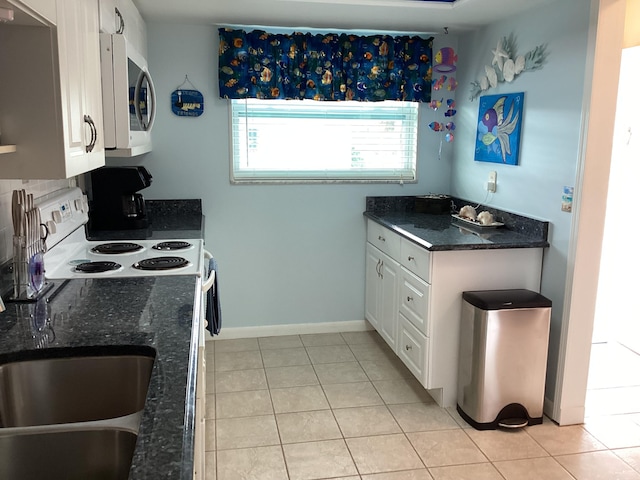 kitchen featuring white cabinetry and light tile patterned floors