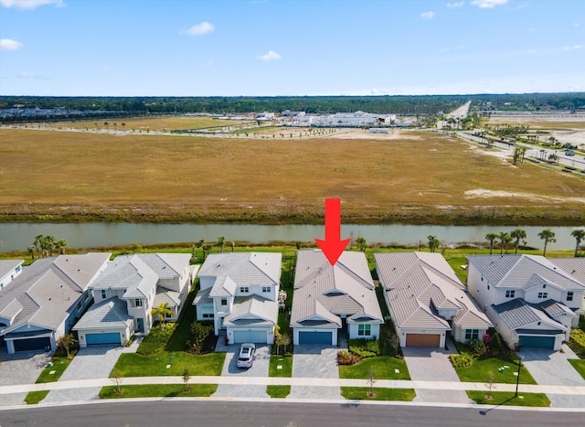 bird's eye view featuring a water view and a residential view