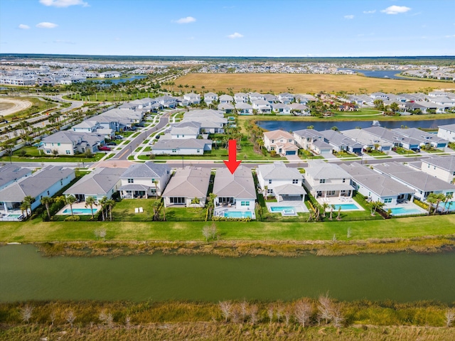 bird's eye view with a water view and a residential view