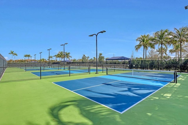view of tennis court featuring fence