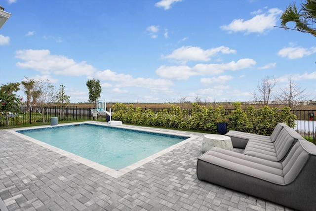 view of swimming pool featuring a patio, a fenced backyard, and a fenced in pool