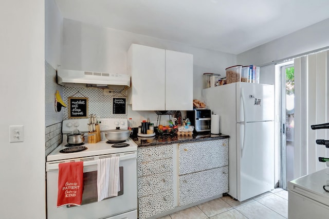 kitchen featuring light tile patterned floors, white appliances, tasteful backsplash, and white cabinets