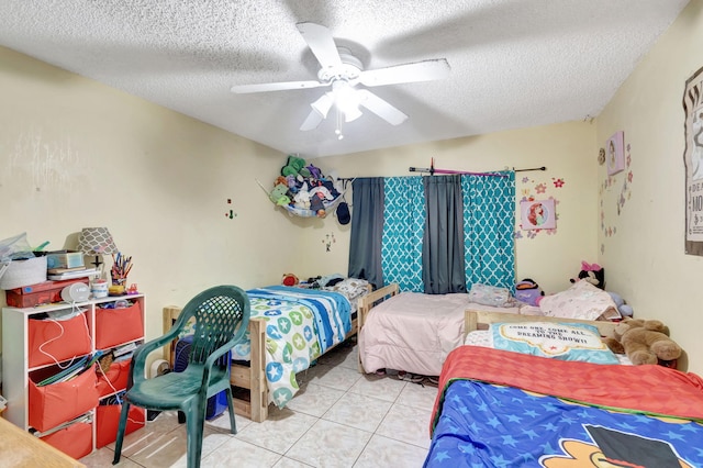 tiled bedroom featuring a textured ceiling and ceiling fan