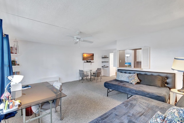 living room with a ceiling fan, carpet, and a textured ceiling