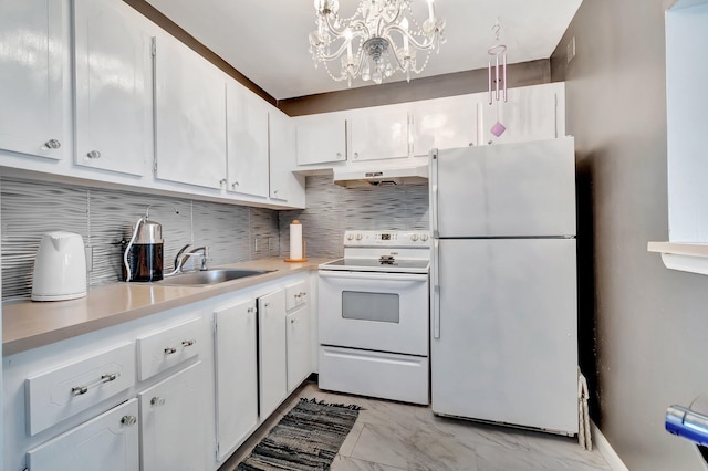 kitchen featuring white appliances, white cabinetry, a sink, and under cabinet range hood