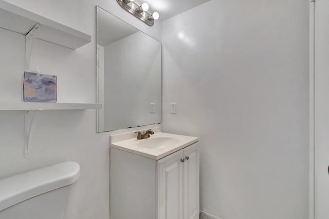 half bathroom featuring toilet and vanity