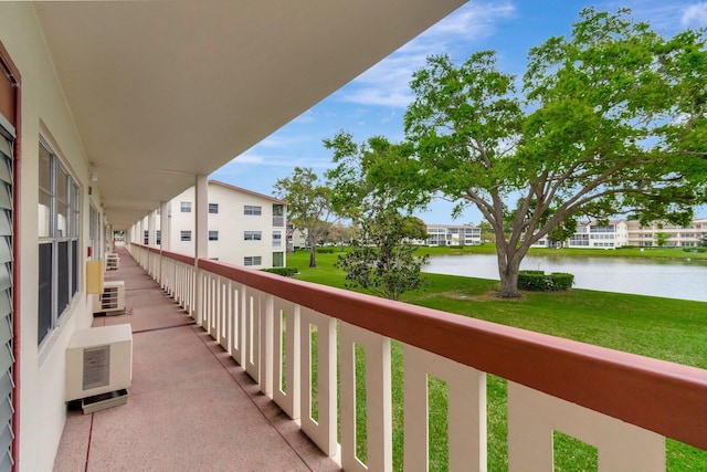 balcony with a residential view and a water view