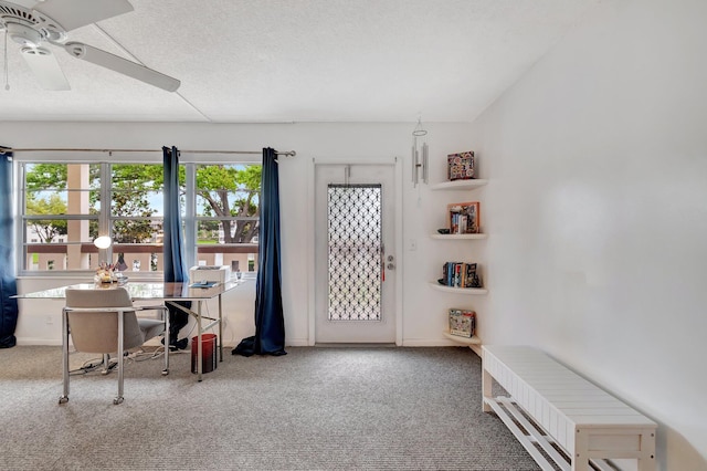 home office with ceiling fan, a textured ceiling, baseboards, and carpet flooring