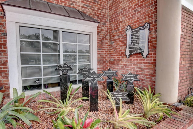 property entrance featuring brick siding